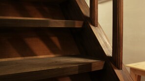 A wooden staircase with a dark finish.