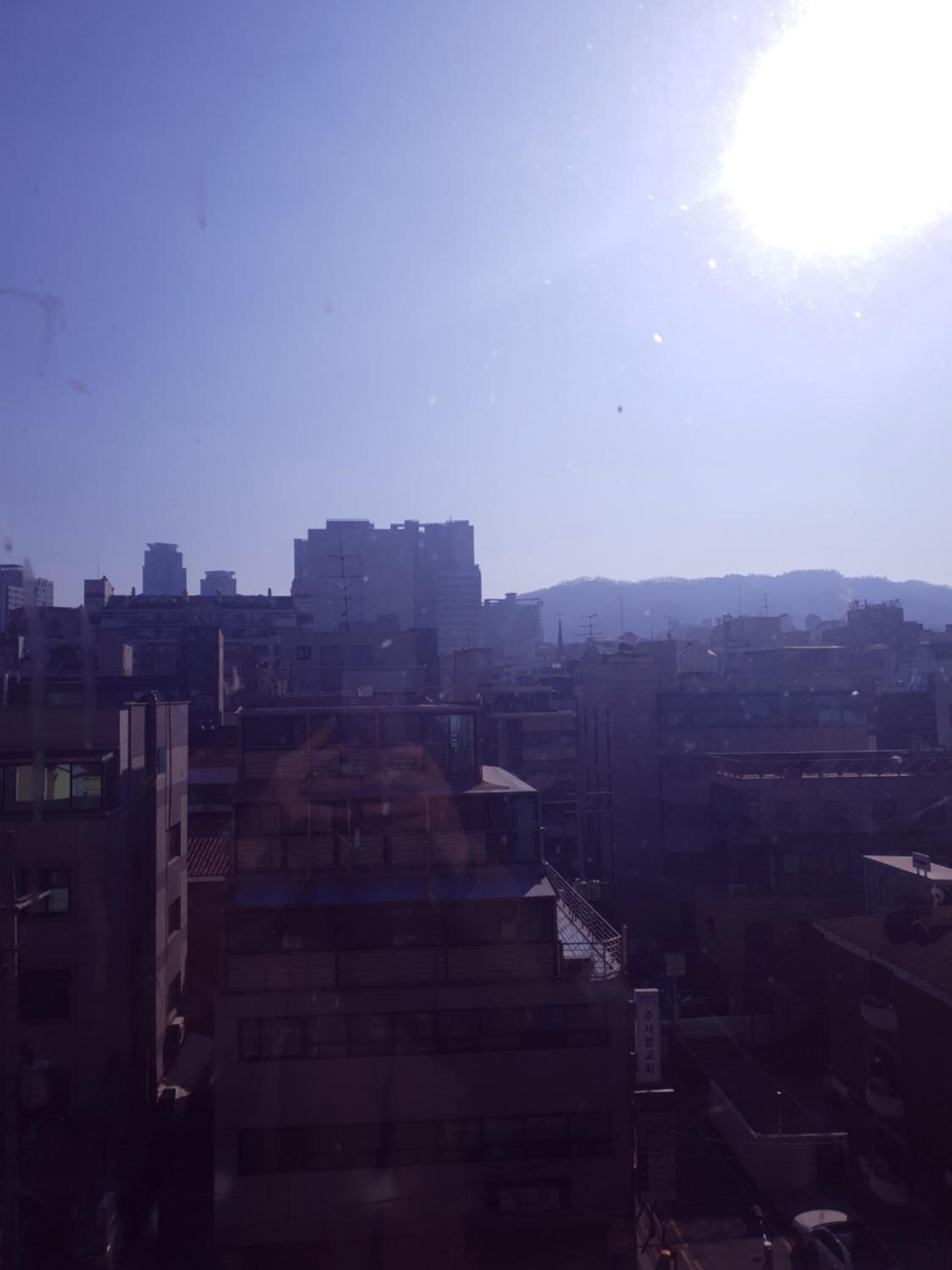 A cityscape with multiple buildings under a clear sky.
