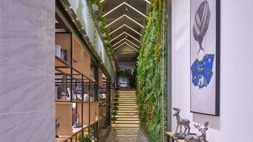 A modern interior with a staircase, green wall, and decorative items.