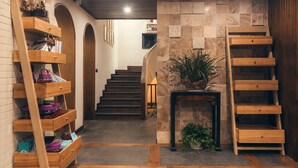 A staircase leading to a second floor with wooden shelving units on either side. - Floral Hotel Wuxi Qietintfengyin Resort (Wuxi)
