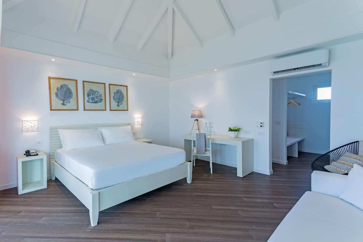 over water villa | minibar, desk, iron/ironing board, bed sheets