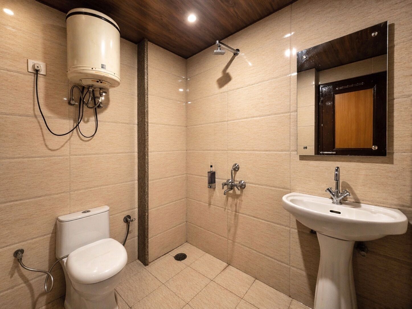 A bathroom with a toilet, sink, shower, and a water heater.
