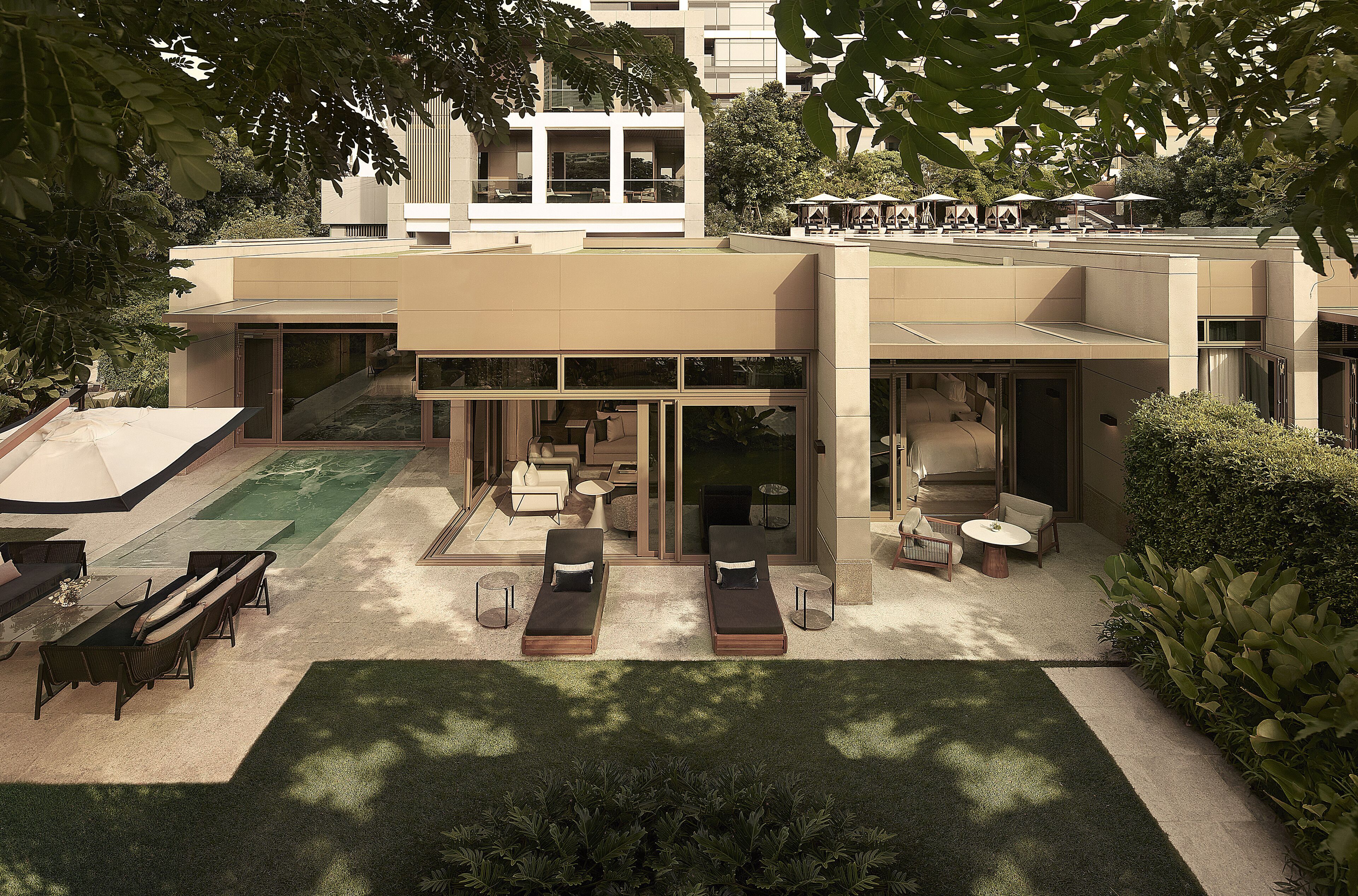 A modern house with a patio area featuring outdoor furniture and a swimming pool.