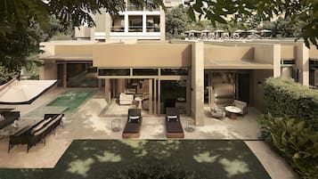 A modern house with a patio area featuring outdoor furniture and a swimming pool.