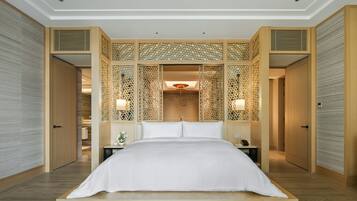 A modern hotel room with a large bed, wooden paneling, and a view of the hallway.