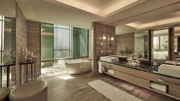 A modern bathroom with a freestanding bathtub, a large vanity with dual sinks, and a large mirror.