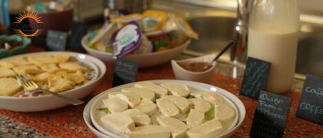 A buffet with various dishes including tofu, cheese, and coffee.