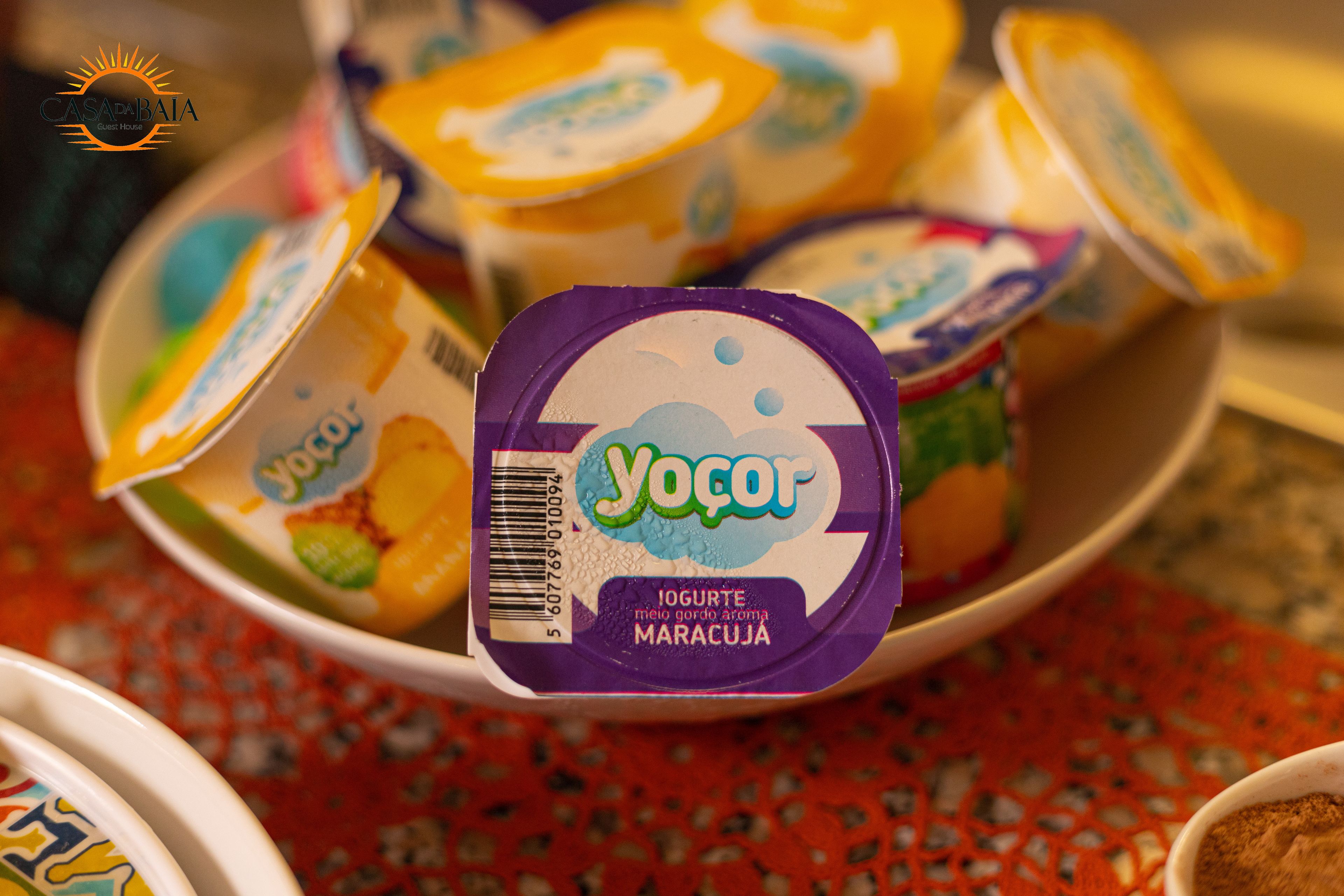 A bowl of yogurt cups with a purple lid and a barcode.