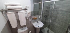 Apartamento standard | Banheiro | Chuveiro, produtos de toalete grátis, secador de cabelo 