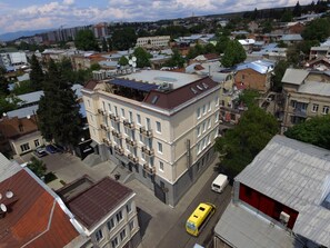 Stylish building with a symmetrical facade and solar panels on the roof.