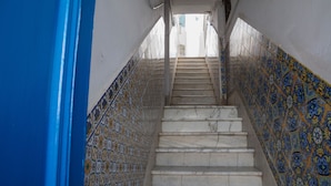 A staircase with blue and white patterned tiles on the walls. - Charmin & Trendy Apartment Marsa Beach (La Marsa)