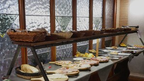 A buffet table with various food items and a bottle of milk. - LH Hotel il Picchio (Pescasseroli)