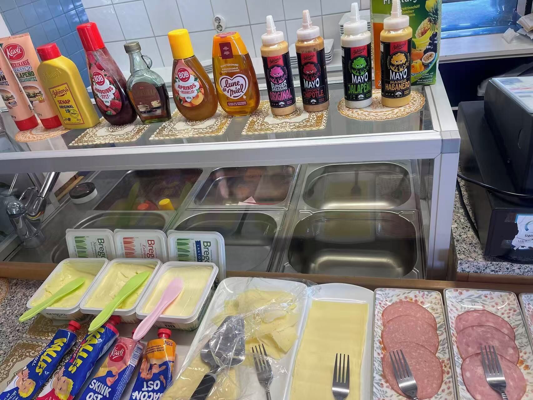 A buffet area with various condiments, sauces, and food items.