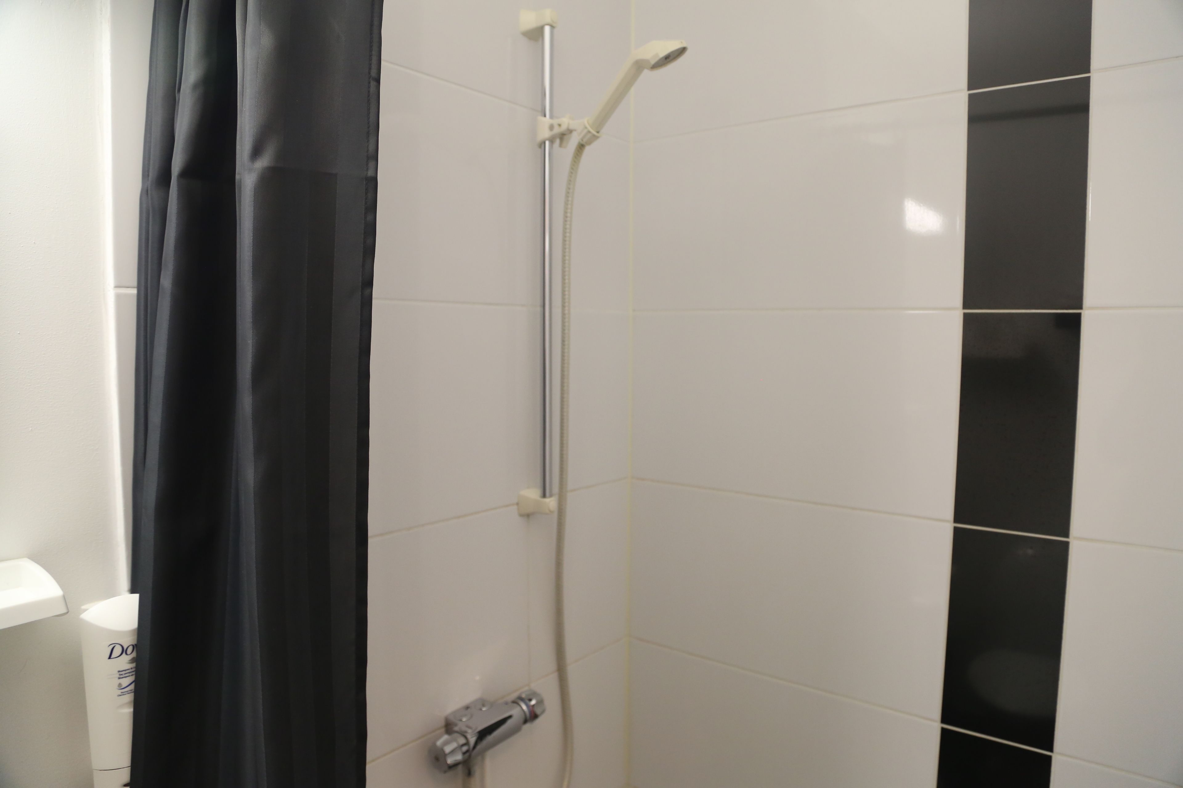 Un baño con ducha, inodoro y lavamanos.