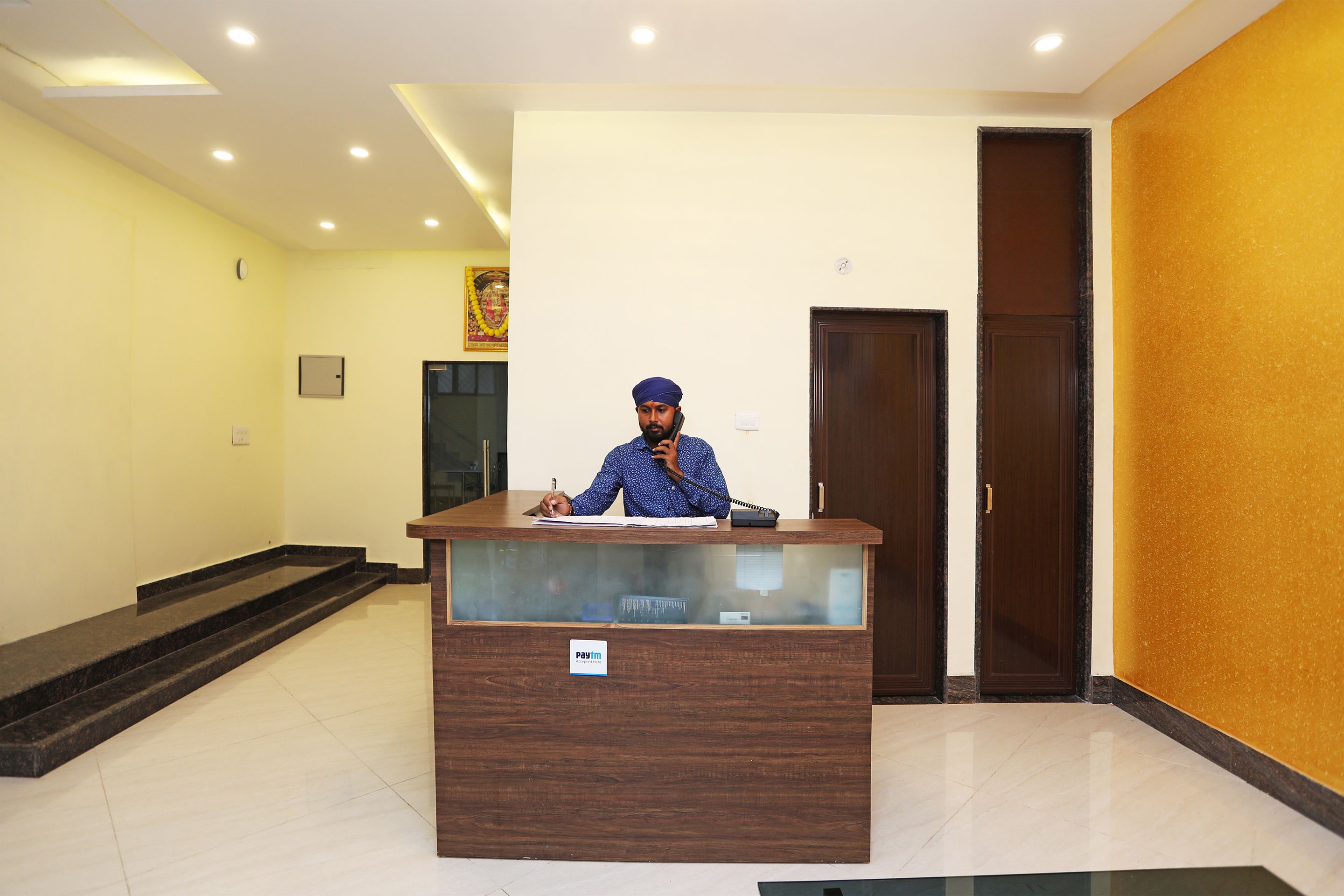 A reception desk with a sign indicating 'post room' in a hotel lobby.