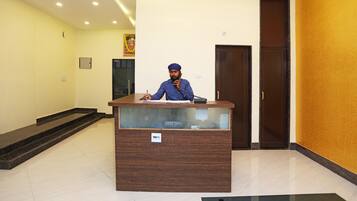 A reception desk with a sign indicating 'post room' in a hotel lobby.