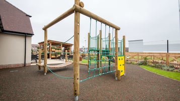Children can play safely on the playground's climbing frame and rubberized surface.