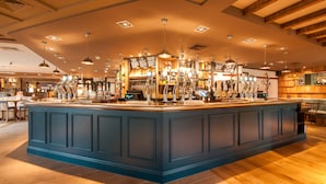 A spacious bar area with multiple bar stools and a central bar counter. - Canterbury Bell, Margate by Marston's Inns (Broadstairs)