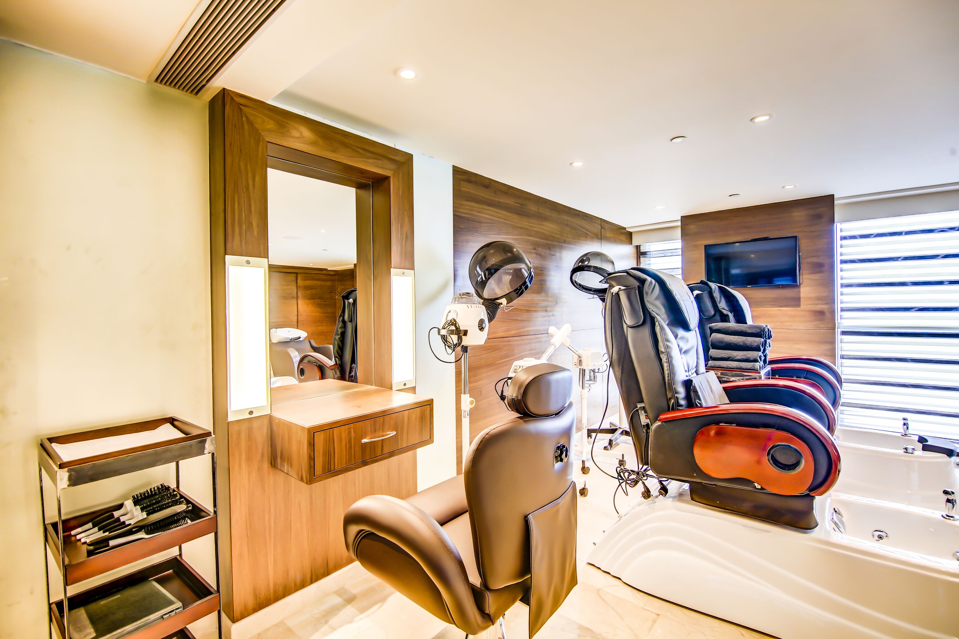 A modern bathroom with a large mirror, a hairdryer, a sink, and a bathtub.