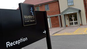 A reception sign with "Marston's" and "Reception" text, a directional arrow, and a building with a reception area in the background. - Fallow Field, Telford by Marston's Inns (Telford)