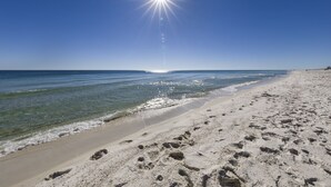 A beach with footprints in the sand and a clear sky. -  Crystal Tower Condos (Gulf Shores)
