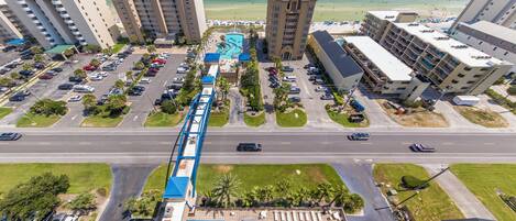 A hotel with multiple buildings, a swimming pool, and a parking lot.