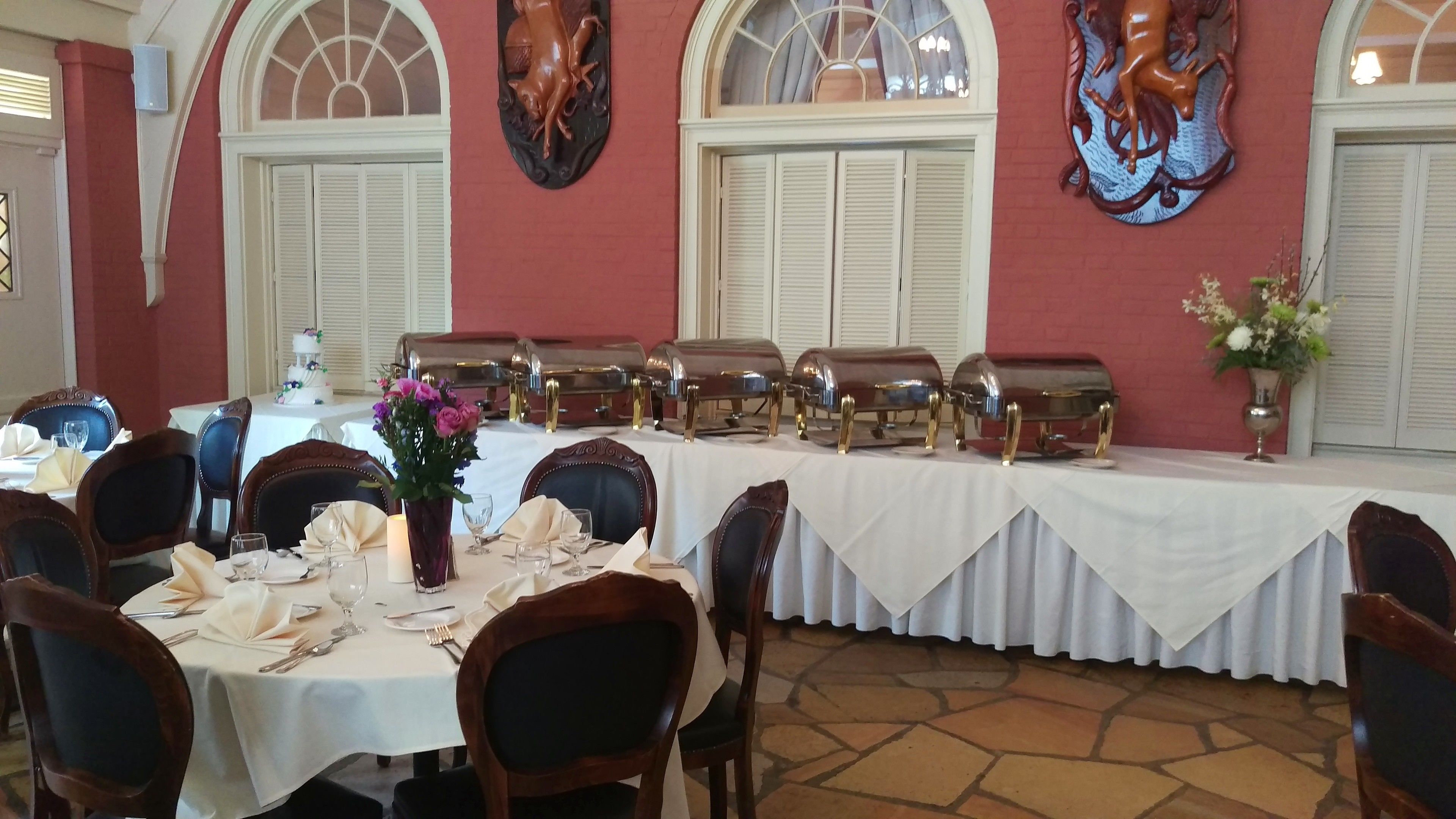 Comedor con una mesa larga dispuesta para una comida, rodeada de sillas.