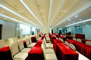 A conference room with rows of tables and chairs, equipped with ceiling lights and a large window. - Xishan Hotel (Taiyuan)