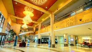 A spacious lobby with a high ceiling, multiple levels, and a central staircase. - Xishan Hotel (Taiyuan)