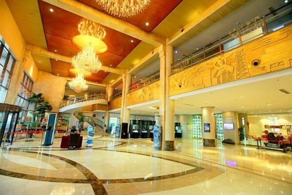 A spacious lobby with a high ceiling, multiple levels, and a central staircase. - Xishan Hotel (Taiyuan)