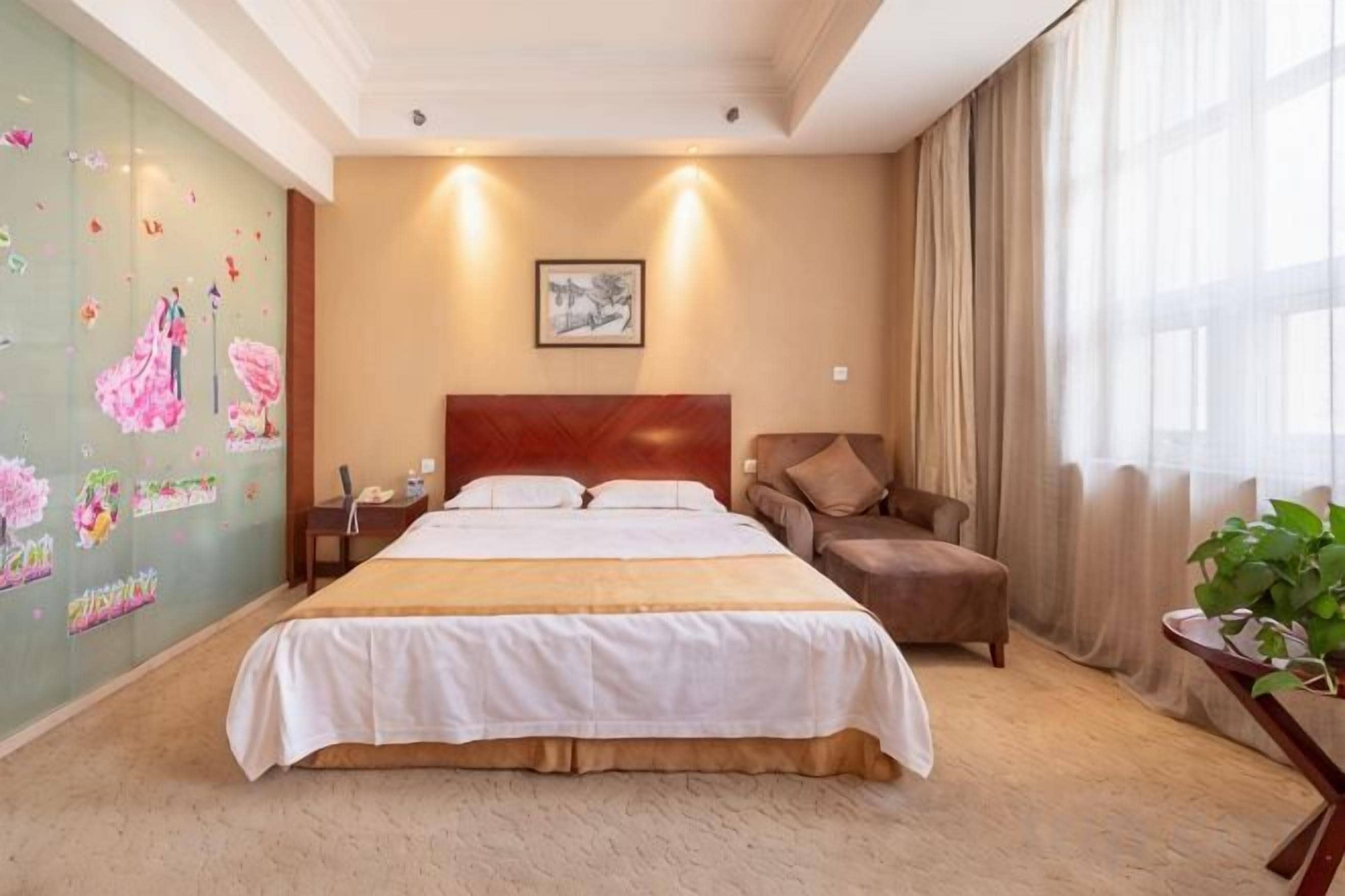 A hotel room with a large bed, a nightstand, a chair, and a window with curtains.
