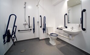 A modern bathroom with a toilet, sink, and shower.
