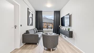 Comfort Apartment, 2 Bedrooms, Private Bathroom, City View | Living room | 65-inch flat-screen TV with cable channels