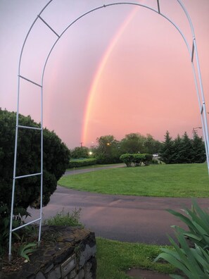 A metal archway in a park with a rainbow in the background. - ANS Inn & Suites (Winchester)