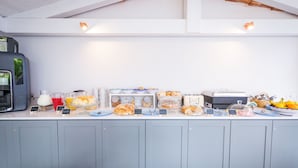 A breakfast buffet with various food items and a coffee machine. - Relais Kaora (Sant'Agnello)