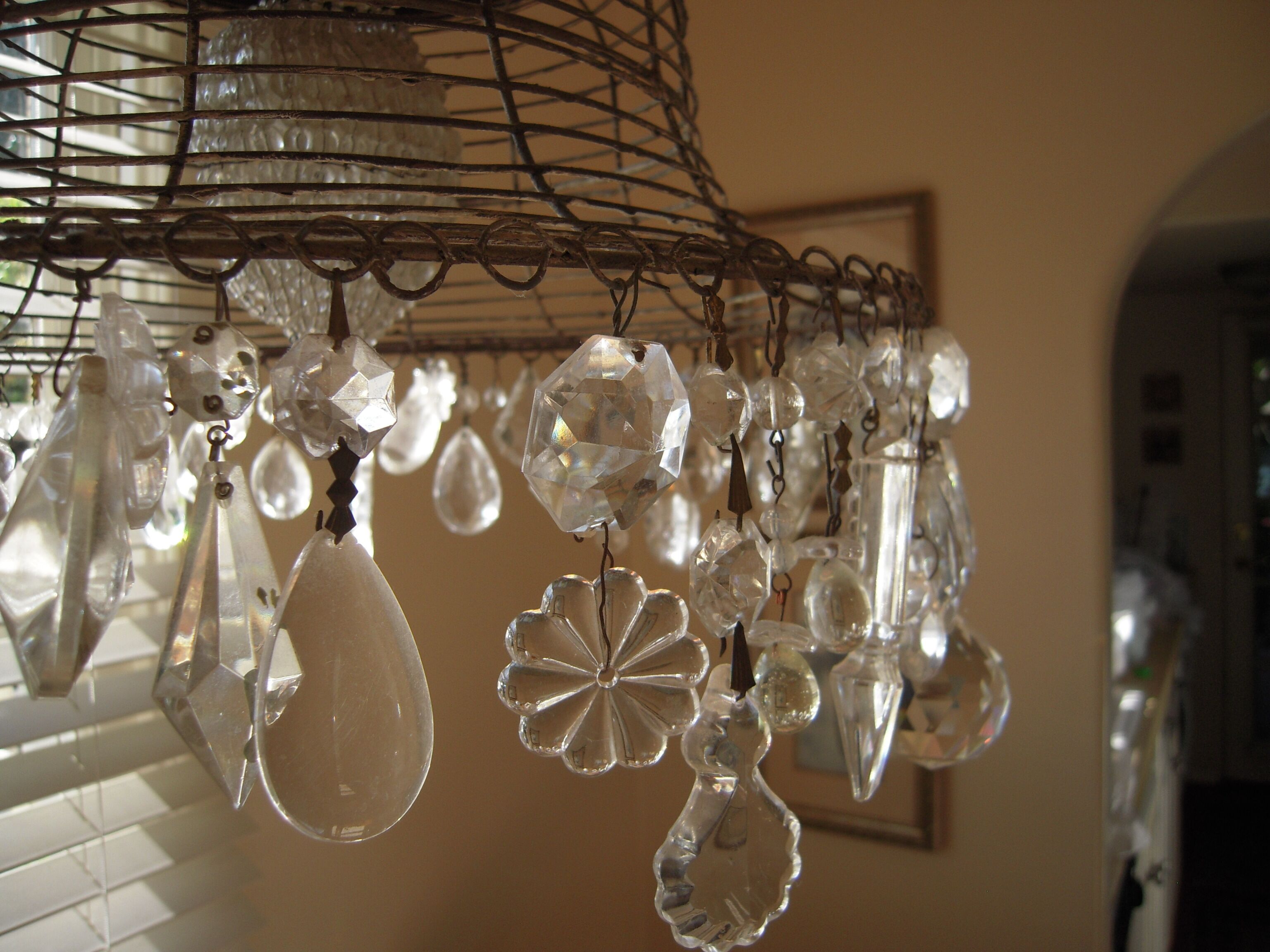 A chandelier with multiple crystal ornaments hanging from a metal frame.