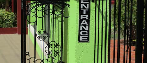 A gated entrance with a sign reading "ENTRANCE" and a push sign.