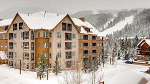 A multi-story hotel with a symmetrical facade, large windows, and a central entrance. - 2 Bedroom Colorado Vacation Rental in River Run Village with Pool and Hot Tub Access (Keystone)