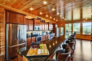 Enjoy cooking with a long island countertop and stainless steel appliances in this well-equipped kitchen.