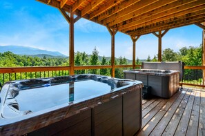 Relax on the deck with a hot tub and sauna, taking in the serene views of the surrounding mountains.