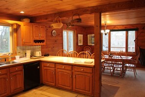 View of Kitchen, Breakfast Bar into Dining Room.