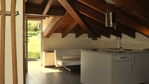 A modern kitchen with a white countertop, a built-in sink, and a wooden ceiling. - Rural apartment Casona la Sierra for 5 people (Cudillero)