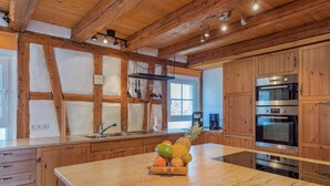 A kitchen with wooden cabinets, a granite countertop, and stainless steel appliances. - Exclusive Country house Seewald - quiete area, Whirlpool, Sauna, large garten, bbq, wifi (Seewald)
