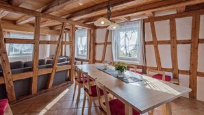 A rustic interior with exposed wooden beams, a long dining table, and a cozy seating area. - Exclusive Country house Seewald - quiete area, Whirlpool, Sauna, large garten, bbq, wifi (Seewald)