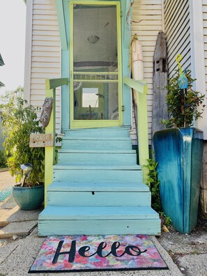 A house with a blue-painted front door, a 'Hello' mat, and a 'Please close door' sign. - 5 Blocks from the Waterfront! Walk to everything! Very desirable location! (Grand Haven)