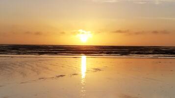 On the beach, sun loungers, beach towels