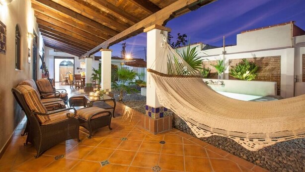 A covered patio area with wicker furniture, a hammock, and a pool. - Private Pool, walk to malecón, 2 HB estilo hacienda (La Paz)