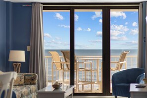 A room with a view of the ocean, a sofa, a chair, a table, and a lamp. - Beautiful Ocean Front 3rd Flr Condo (North Myrtle Beach)