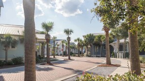 A paved street lined with palm trees and buildings with a clear sky. - Seacrest Luxury Beach House - Sleeps 14 (Seacrest Beach)