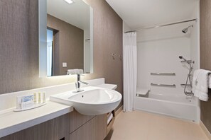 A modern bathroom with a large sink, mirror, and shower area. - SpringHill Suites by Marriott Ocala (Ocala)